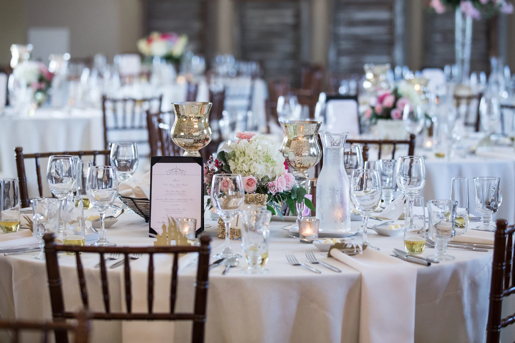 Elegant Connecticut event reception arranged with flowers, candles and coordinated place settings