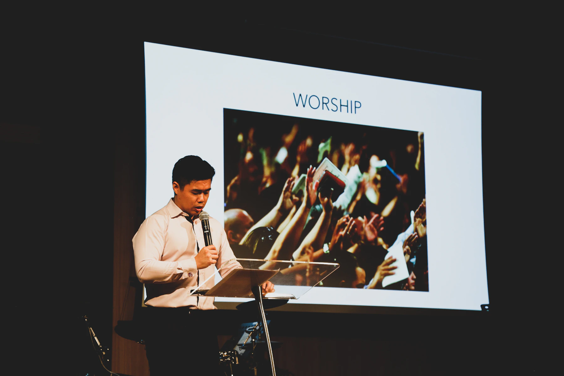 Speaker presenting on stage during a professionally produced corporate event