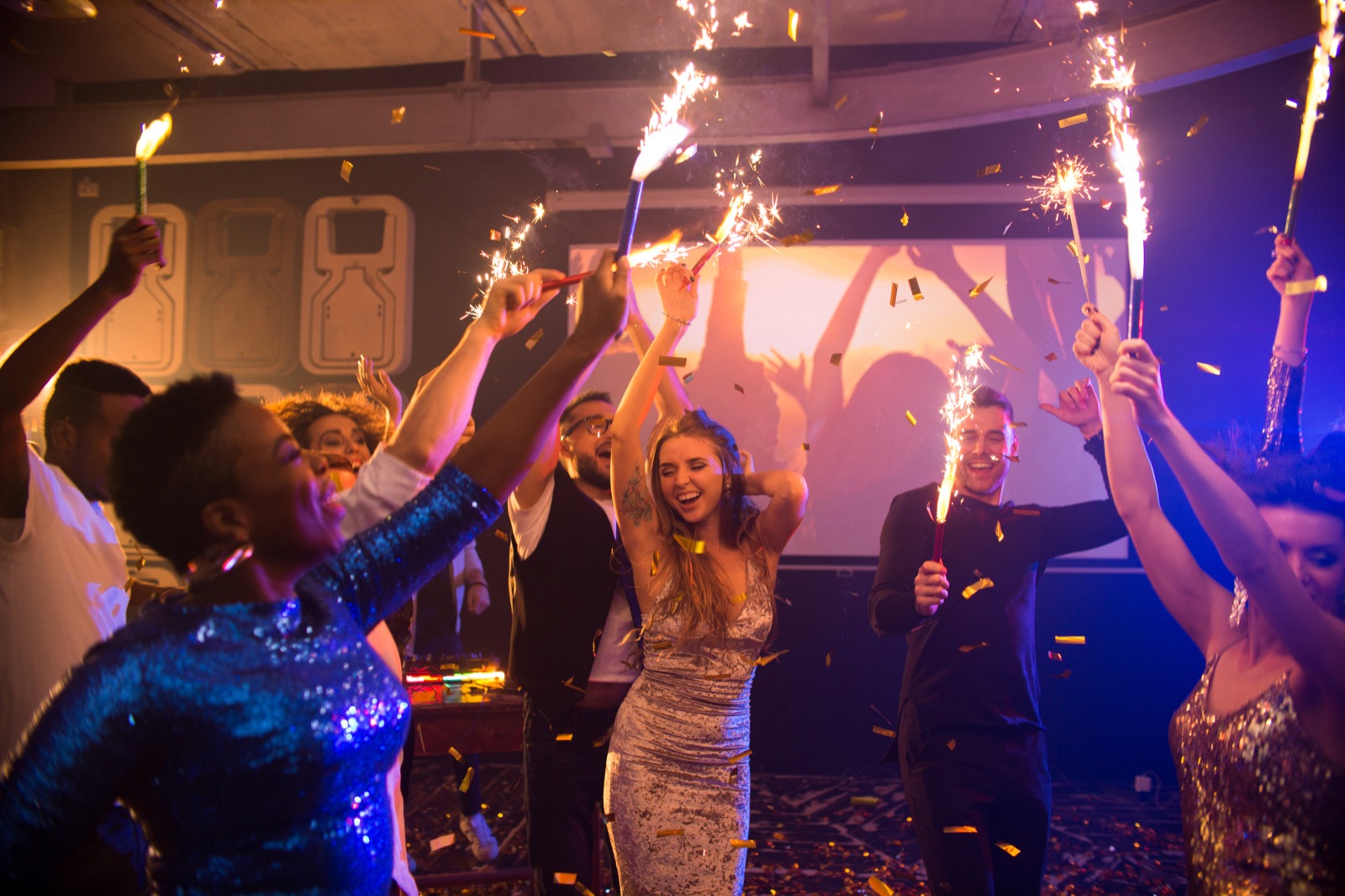 Friends celebrating together with sparklers at a Connecticut private event